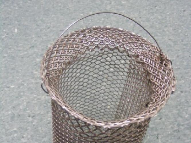 An empty drain basket that can be placed above drains to avoid blockages from substrate when cleaning enclosures