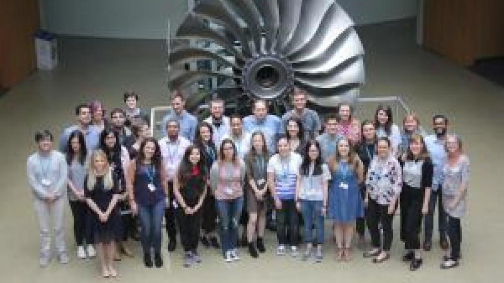 Students standing in front of a large turbine