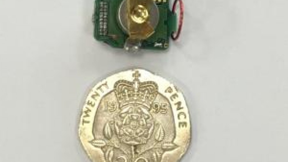 A TaiNi device which is a small ultra lightweight system for recording neural activity in the brains of mice and a 20 pence piece to show the device size in comparison