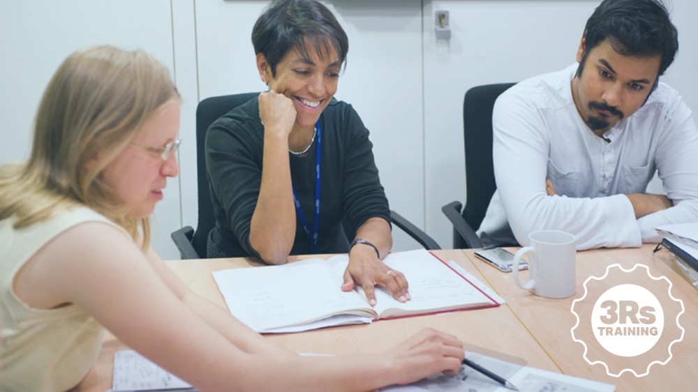 Researchers working on a document at a table