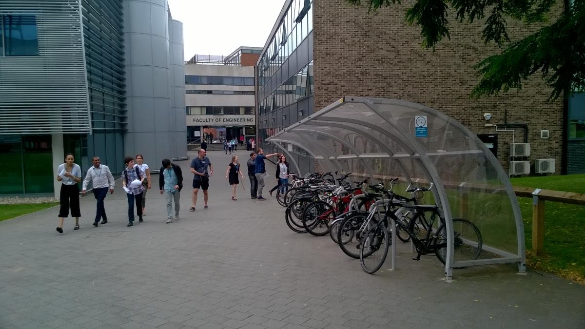 A bike shed on the right and students walking by on the right