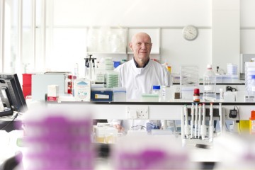 Long range camera shot of Dr Keith Redhead in a laboratory 