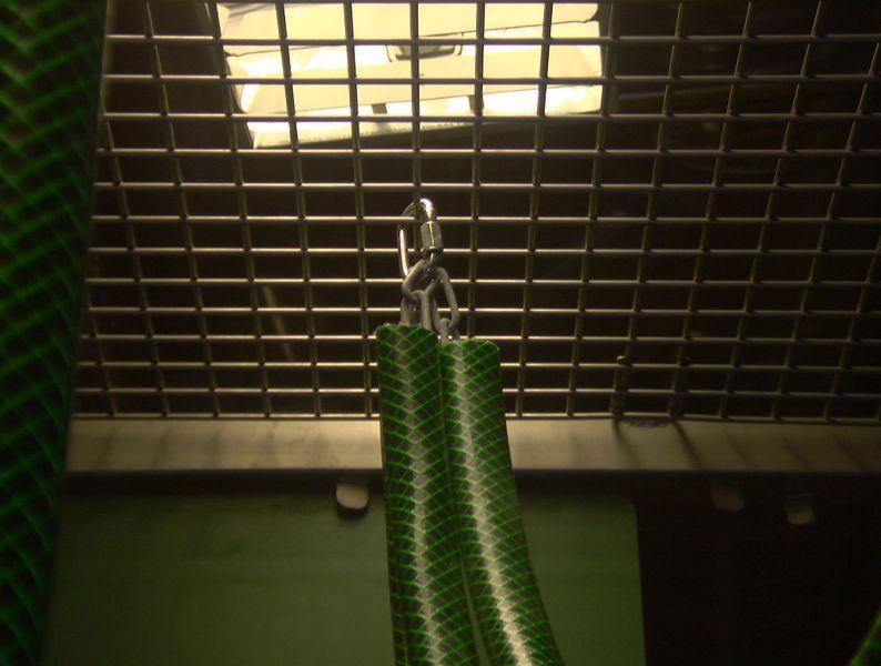 A mesh ceiling provides an additional surface from which to hang enrichment and climbing structures. Here chains have been inserted into water hosing to reduce the risk of the monkeys’ digits being caught in the links.